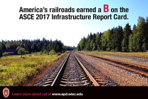 a railroad going through a forest.